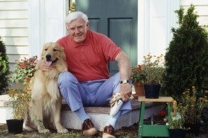 man and golden retriever on doorstep