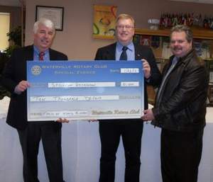 Rotary Rotary Club members present $10,000 check.