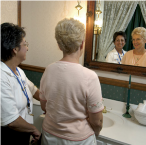 elder_in_bathroom two ladies look in bathroom mirror